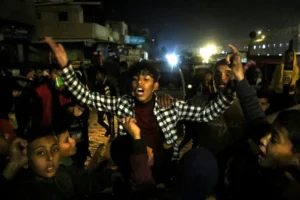 Palestinians react as they wait for news of a ceasefire deal with Israel, in Khan Younis in southern Gaza